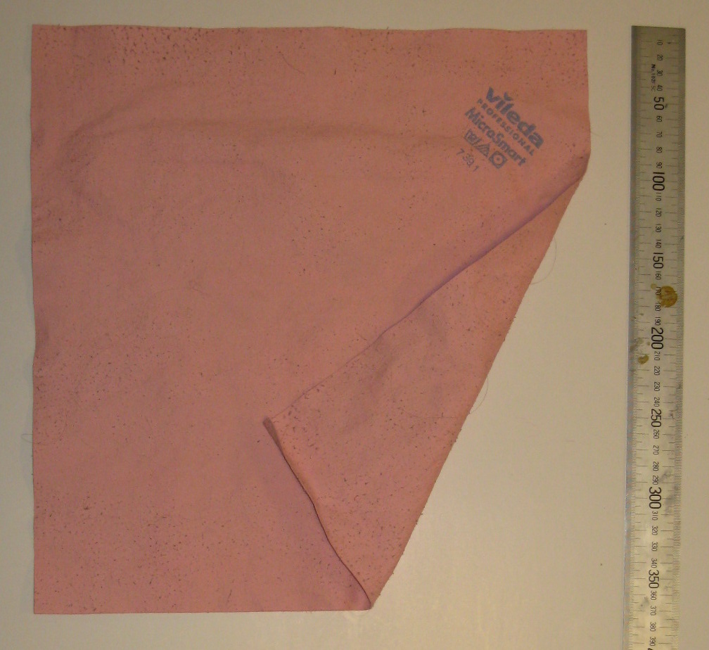 A pink flat-weave microfibre cloth laid out and folded back at one corner